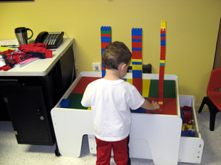 young boy building a Lego tower