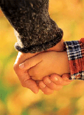 adult and child's hands clasped