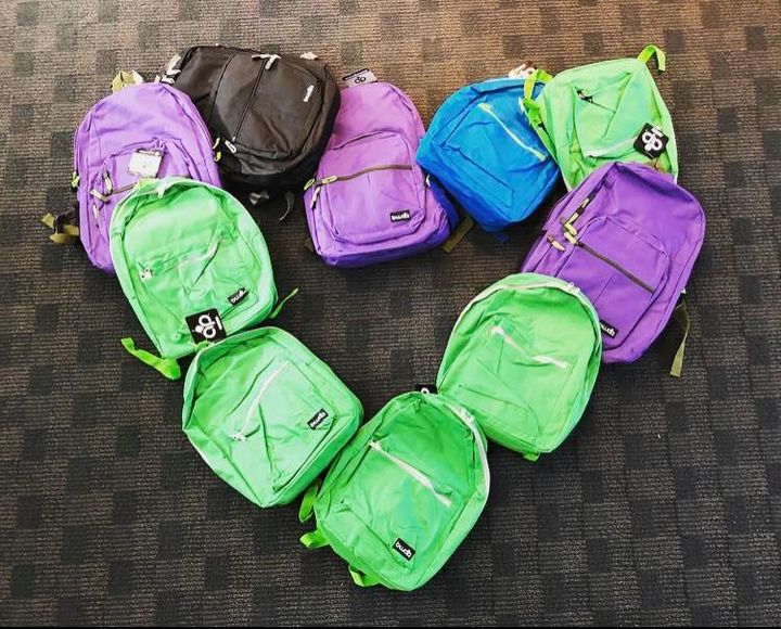 backpacks displayed in the shape of a heart.